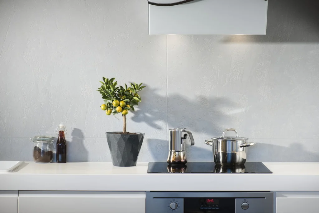 silver pot on top of induction oven