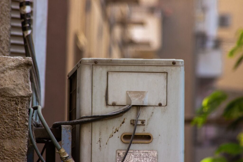 an old electrical box on the side of a building
