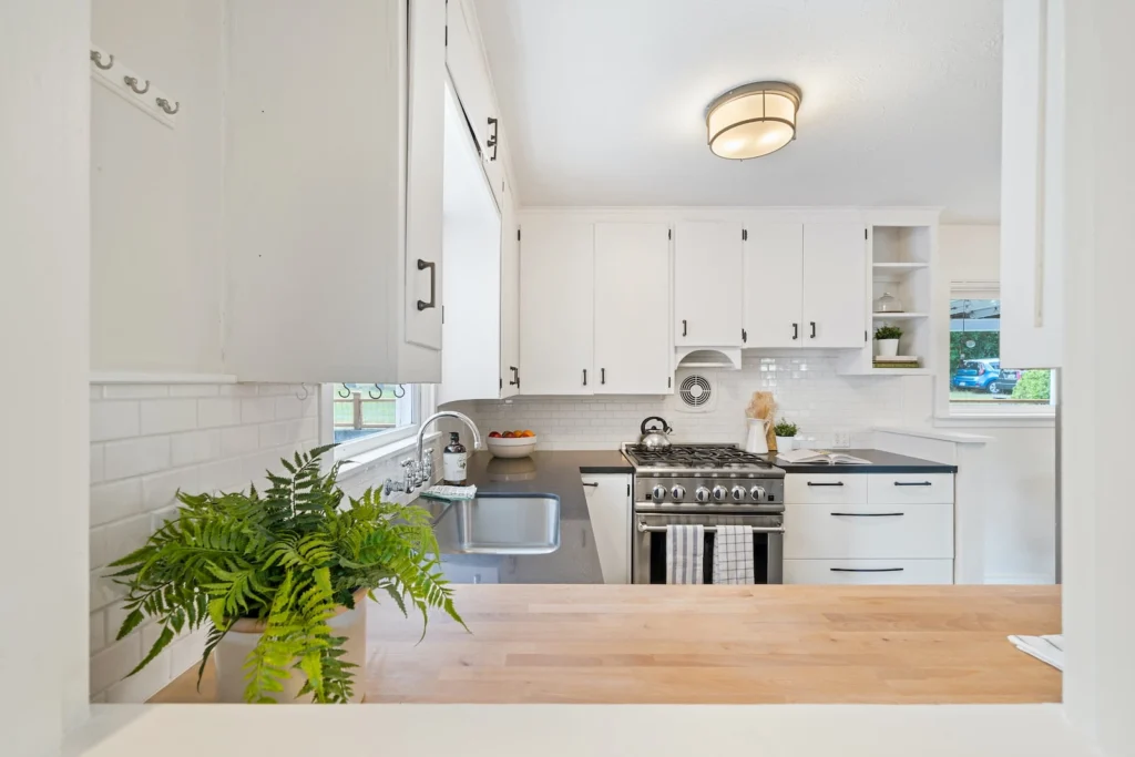 white wooden kitchen cupboards and gray gas stove