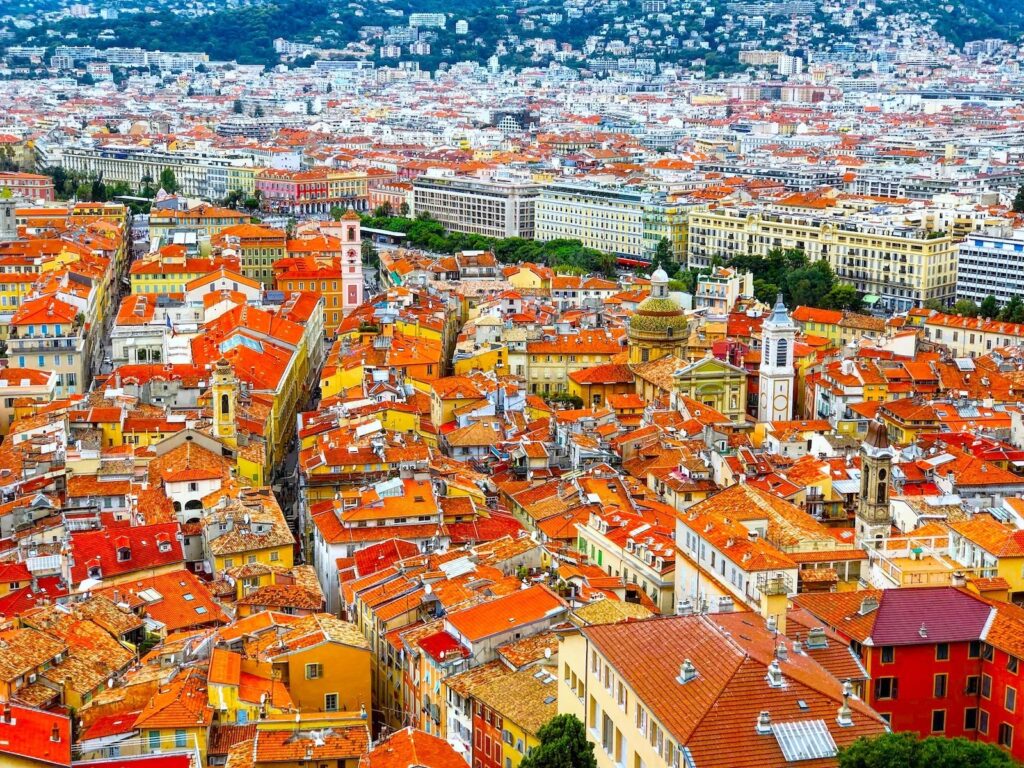 an aerial view of a city with red roofs