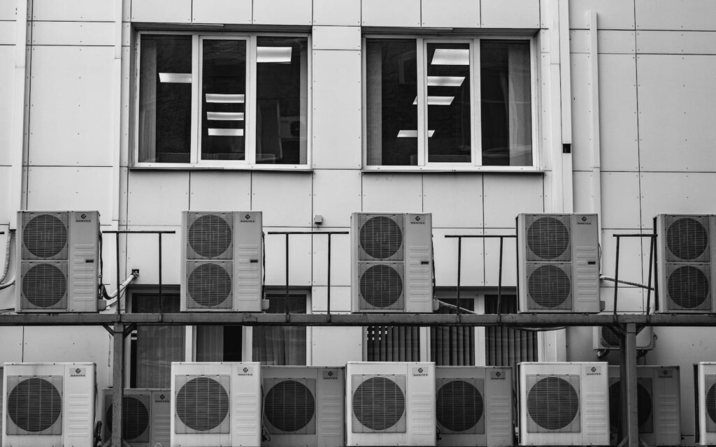 a row of air conditioners in front of a building